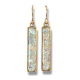 Pair of gold earrings with rectangular gemstones on a white background