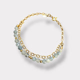 Double bracelet with small blue aquamarine stones and a gold chain