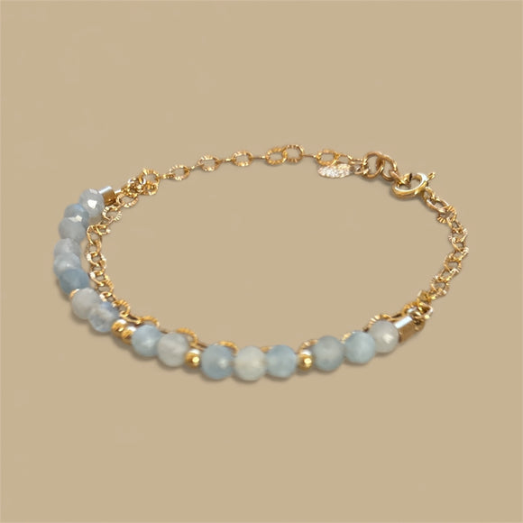 Double bracelet with small blue aquamarine stones and a gold chain