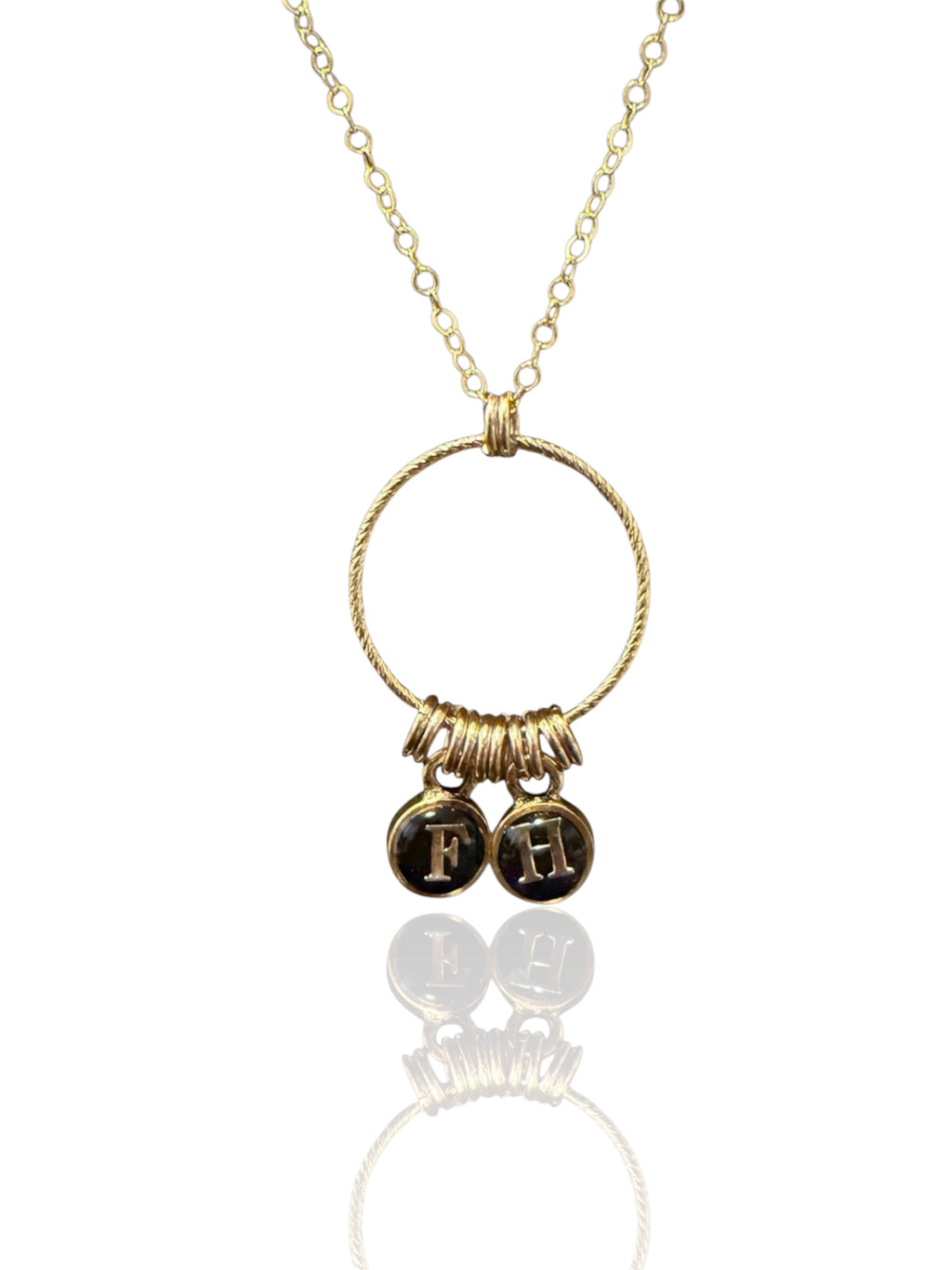 Gold initial necklace with two black and gold letter charms F and H on a gold-filled chain