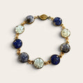 Blue crushed gemstone bracelet with lapis lazuli, sodalite, and larimar set in resin in gold filled links with a magnetic clasp, handmade by June & Simple