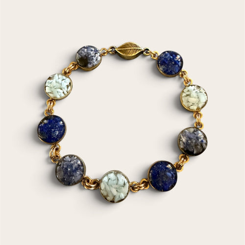 Blue crushed gemstone bracelet with lapis lazuli, sodalite, and larimar set in resin in gold filled links with a magnetic clasp, handmade by June & Simple