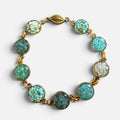 Turquoise crushed gemstone bracelet with nine circles of turquoise, amazonite, and blue apatite set in resin in gold filled links with a magnetic leaf clasp, handmade by June & Simple
